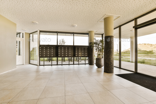 the lobby of a building with glass doors and windows