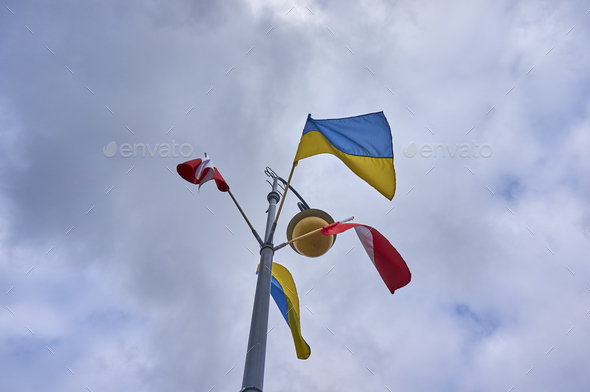Closeup shot of flags of Poland and Ukraine hanging from the lantern