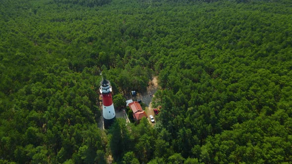 Drone spinning around Stilo Lighthouse and green forest- lighthouse located in Osetnik (formerly Sti alt