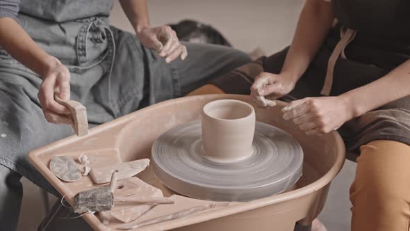 Women Working on Pottery Wheel in Workshop alt