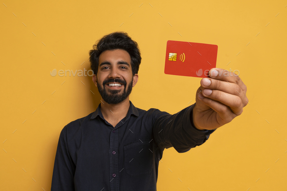 Cheerful Indian Man Showing Credit Card To Camera, Advertising Great Bank Offer