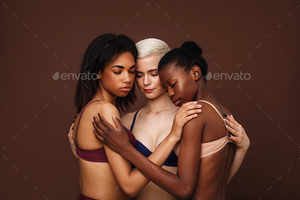 Group of beautiful young women hugging together in their underwear