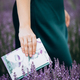 Portrait of young woman standing in lavender field with a book . High quality photo - PhotoDune Item for Sale