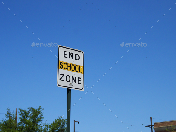 School zone speed restriction zone, with the sign against a blue sky