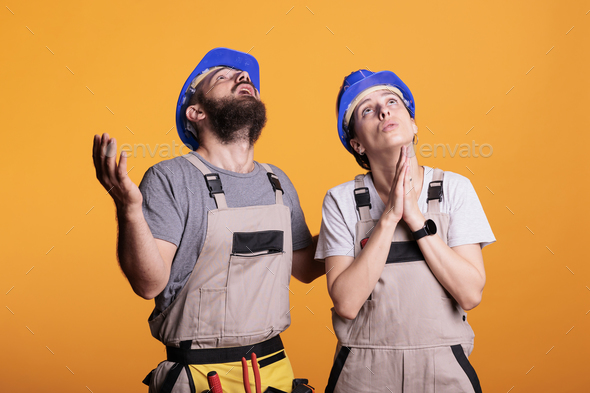 Faithful construction workers praying to god for good projects