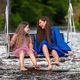 a woman and a young girl are swinging across a fast-flowing river, laughing and splashing with water - PhotoDune Item for Sale