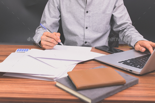 Business people sit at work and check documents At the desk in the room ...