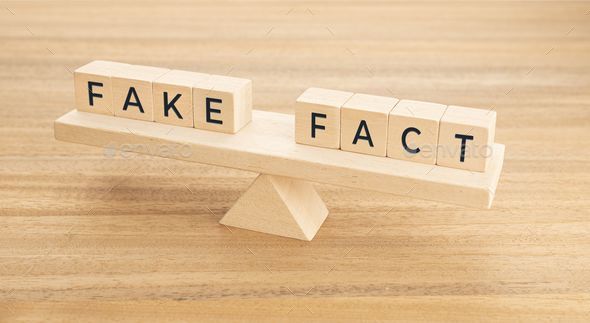 Fake fact words on wooden block on a seesaw