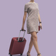 Fashionable woman traveling and pulling a trolley suitcase - PhotoDune Item for Sale