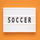 The word soccer on lightbox isolated orange background. - PhotoDune Item for Sale