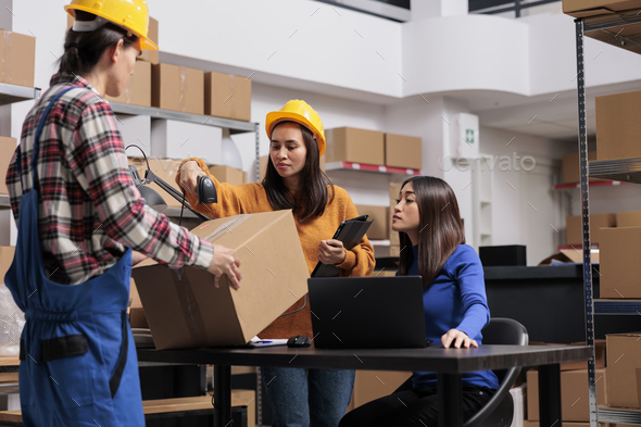 Asian warehouse workers team managing parcels shipping and receiving