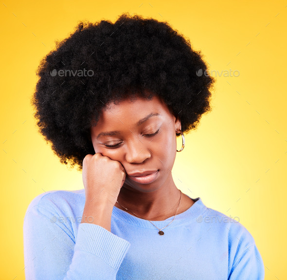 Tired, black woman and hand on face in studio looking sad, fatigue and ...