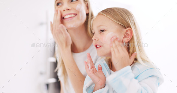 Skincare, mother and daughter home spa day washing their face in bathroom or apply beauty product,