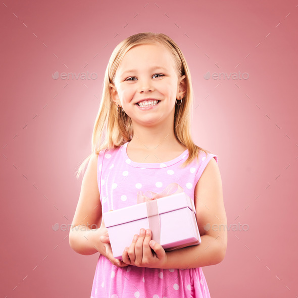 Child, gift or present portrait in studio for birthday, holiday or happy celebration. Excited girl