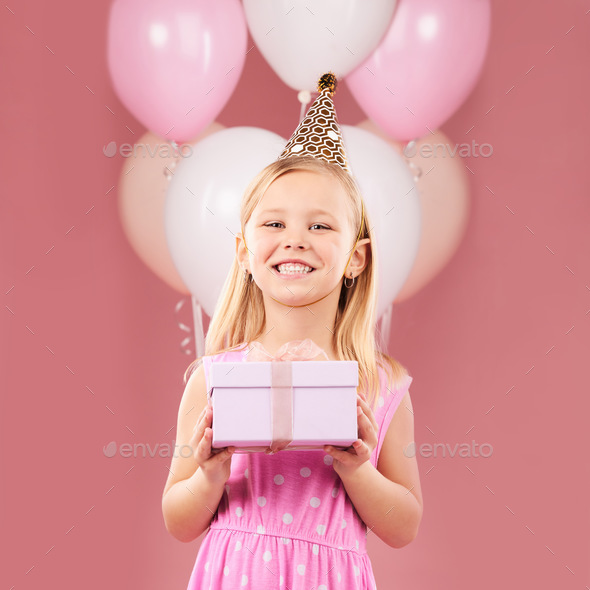 Present, birthday and portrait of a child with balloons in studio for party, holiday or happy celeb