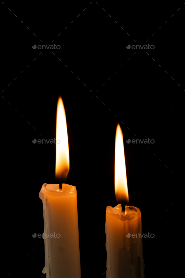 Lit tea candles and candles with copy space on black background Stock Photo  by Wavebreakmedia