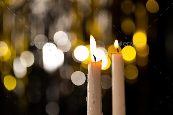 Lit tea candles and candles with copy space on black background Stock Photo  by Wavebreakmedia