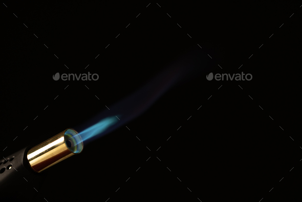 Close up of lit torch light with copy space on black background
