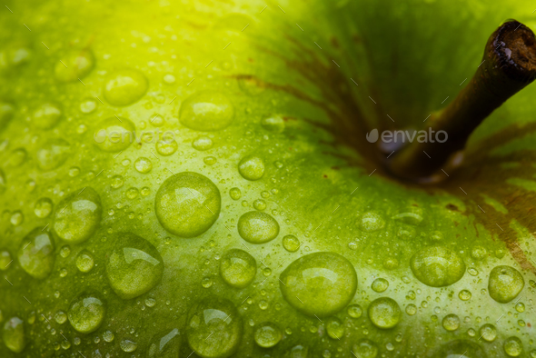 Micro close up of green apple with water drops and copy space