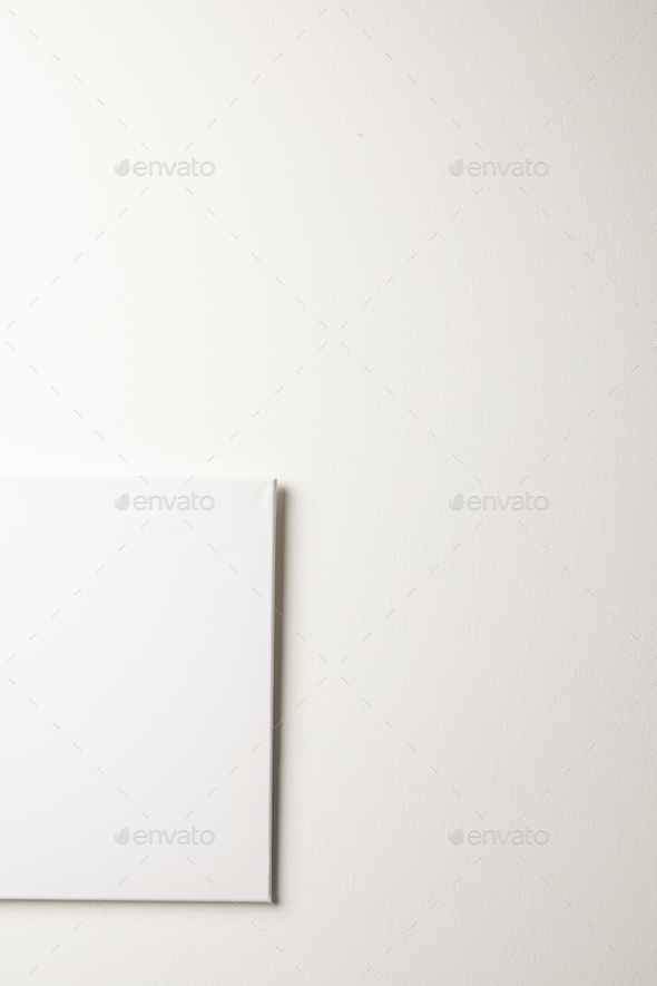 White canvas and copy space hanging in white wall background Stock