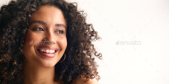 Studio Portrait Of Smiling Natural Woman With Bare Shoulders