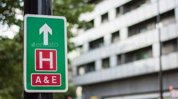 Street sign towards hospital and emergency room in London, UK