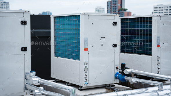 Air conditioner compressor installed on the roof of a building, along with air conditioning.