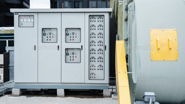 The electrical room of a commercial building contains multiple smart meters, a main power breaker.