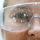 Close up of a woman face wearing protective glasses covered in paint - PhotoDune Item for Sale
