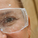 Close up of a smiling woman face wearing protective glasses covered in paint - PhotoDune Item for Sale