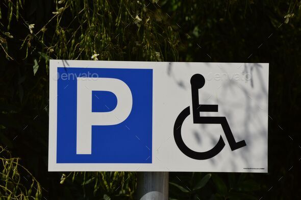 International Road Sign Parking For Disabled People On The Background 