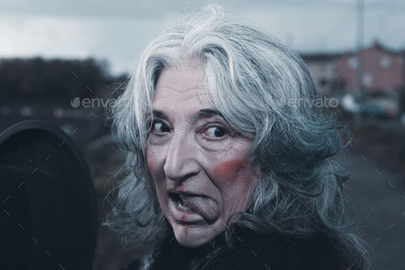 portrait of female dark evil character outdoors a cloudy sad day - evil concept