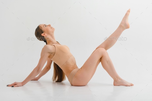 Side view of girl that lying down. Beautiful woman with slim body in  underwear is in the studio. Stock Photo by sedrik2007