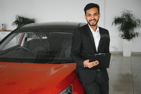 Good Looking, Cheerful and Friendly Indian Salesman Poses in a Car Salon or  Showroom. Stock Image - Image of looking, seller: 270937435