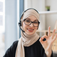 Consultant in headset showing thumbs-up after online chat - PhotoDune Item for Sale