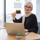Arabian female with credit card running laptop in workplace - PhotoDune Item for Sale