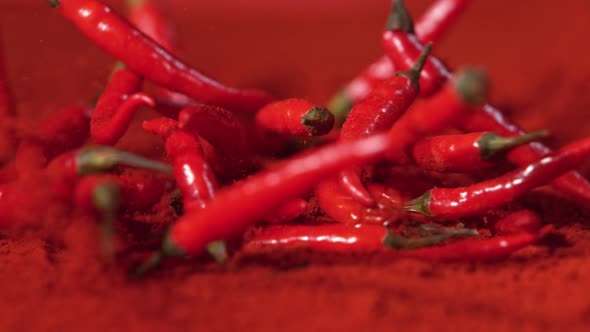 Falling Chilli Peppers Into Powder in Super Slow Motion. alt