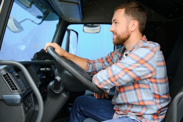 Side View Of Professional Driver Behind The Wheel In Truck's Cabin ...