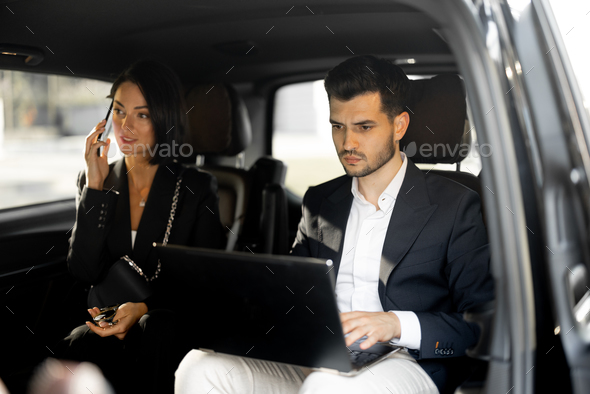 Business people sitting in minivan taxi