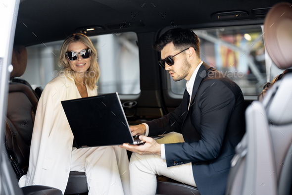 Business people sitting in minivan taxi