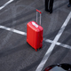 Red suitcase on asphalt of parking lot - PhotoDune Item for Sale