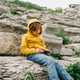 School kid child playing with his cellphone smartphone in an ancient stone amphitheater. Boy in - PhotoDune Item for Sale
