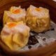 Close up fresh boiled dumplings with hot steams on wood plate - PhotoDune Item for Sale