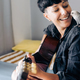 Happy woman and parrot bird enjoying together with guitar at home - Owner and pet relationship, love - PhotoDune Item for Sale