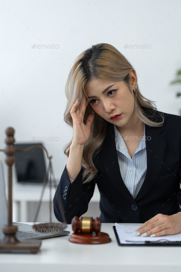Businesswoman, lawyer, legal counsel sitting at work Tired and stressed with business contract paper
