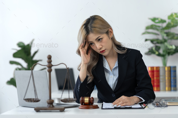 Businesswoman, lawyer, legal counsel sitting at work Tired and stressed with business contract paper