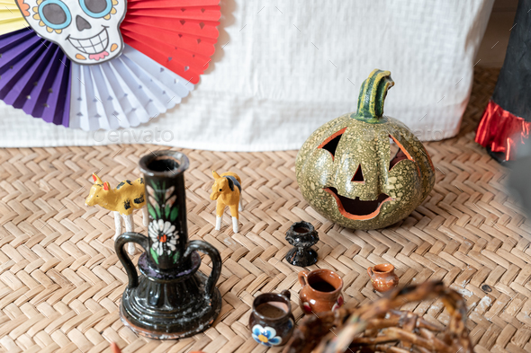 A ceramic gourd next to other adornments decorating a Day of the Dead sleeping mat
