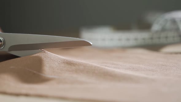 Cut the Bright Yellow Fabric with Scissors Closeup alt