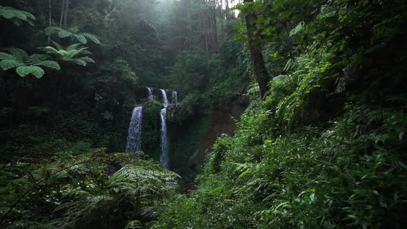 beautiful view through the dense green jungle in indonesia on the grenjengan kembar waterfall alt