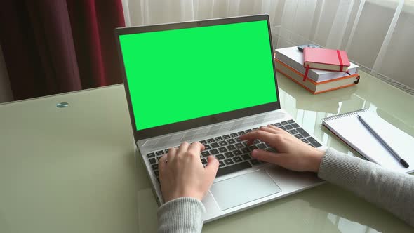 The girl working at home office hands on keyboard. alt